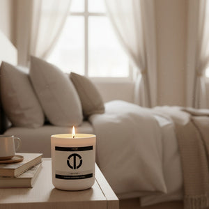 loft81 home desire candle glowing in a bright cozy bedroom soft morning light clean burning coconut soy candle for relaxation wellness and minimalist home decor